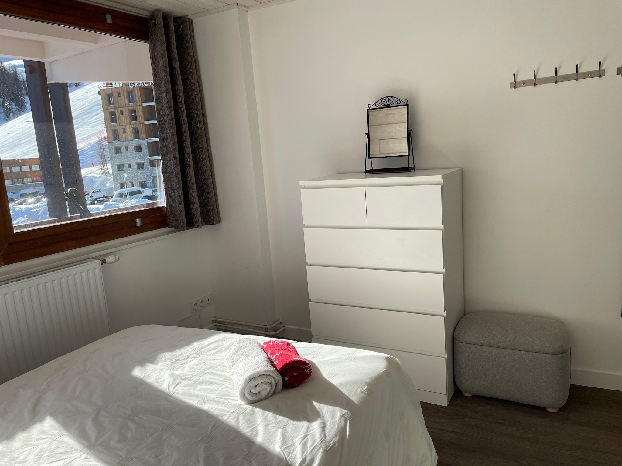 Bedroom with chest of drawers and a slope-facing window