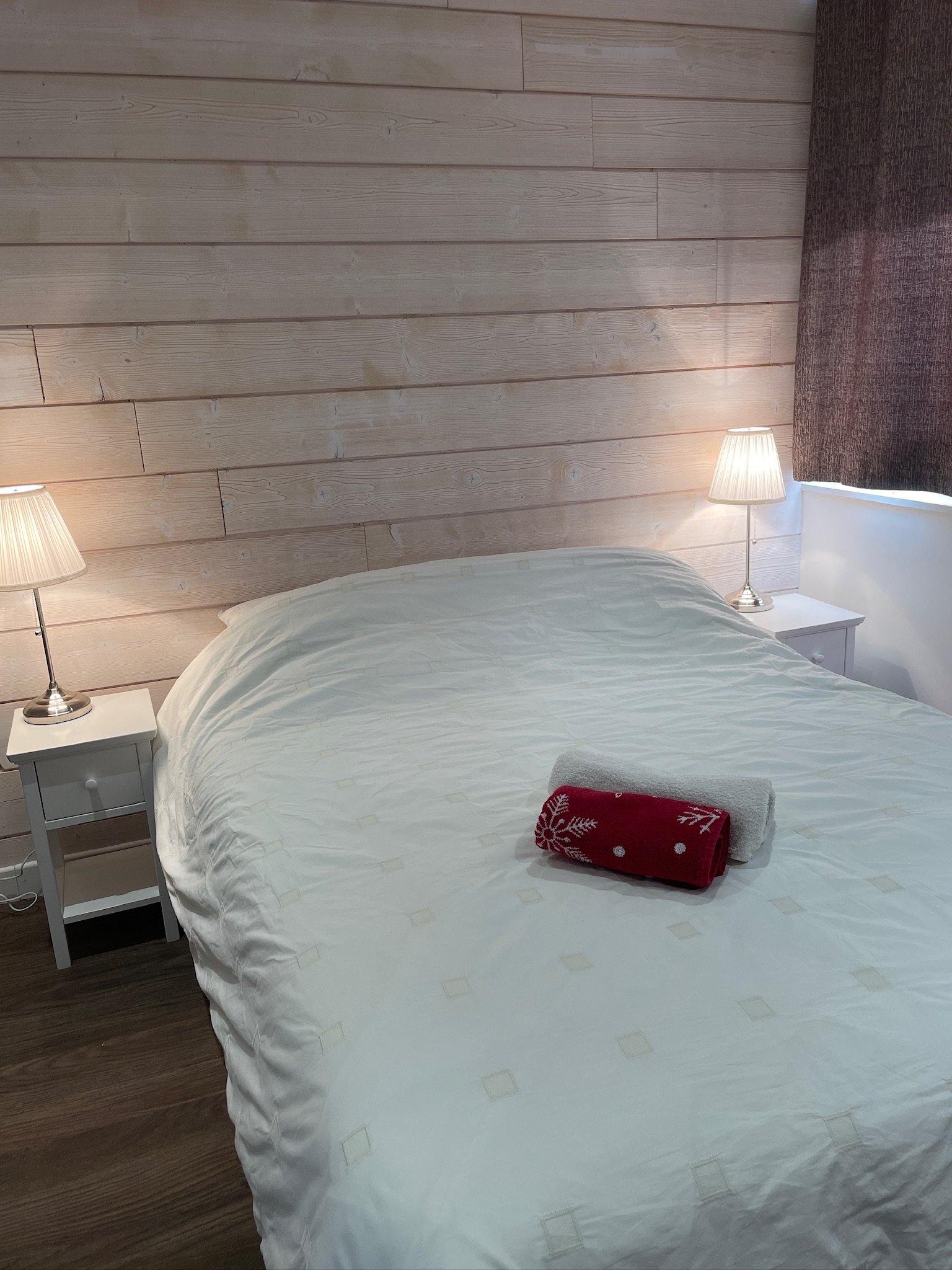 Double bedroom at SnowBadgers with pale wood panelling